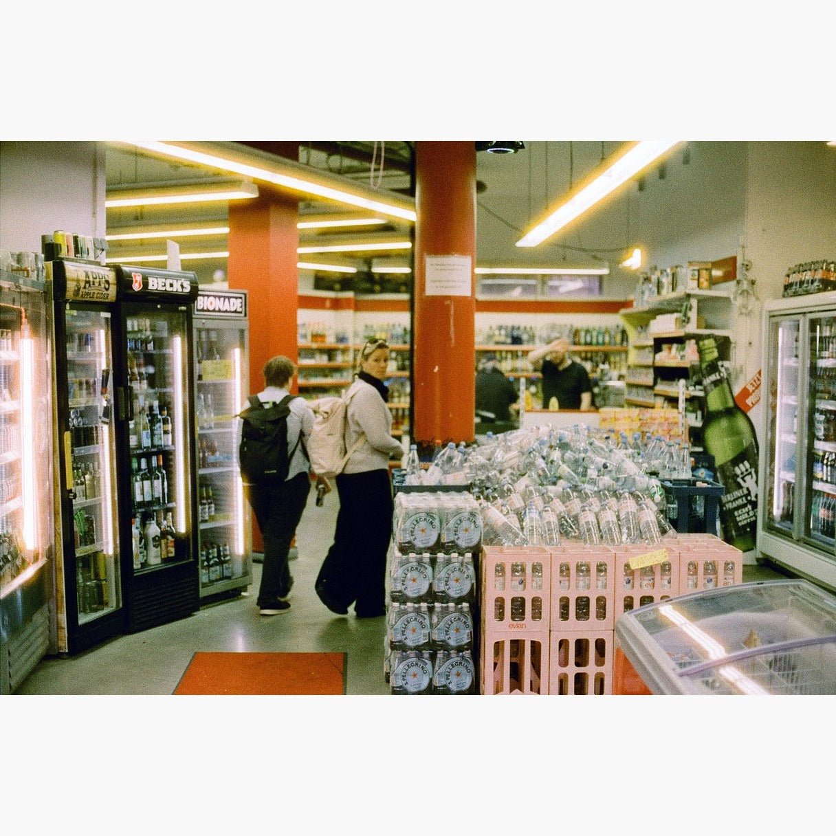 two people inside a supermarket - Harman Phoenix II 200 ISO 35mm colour negative film example image